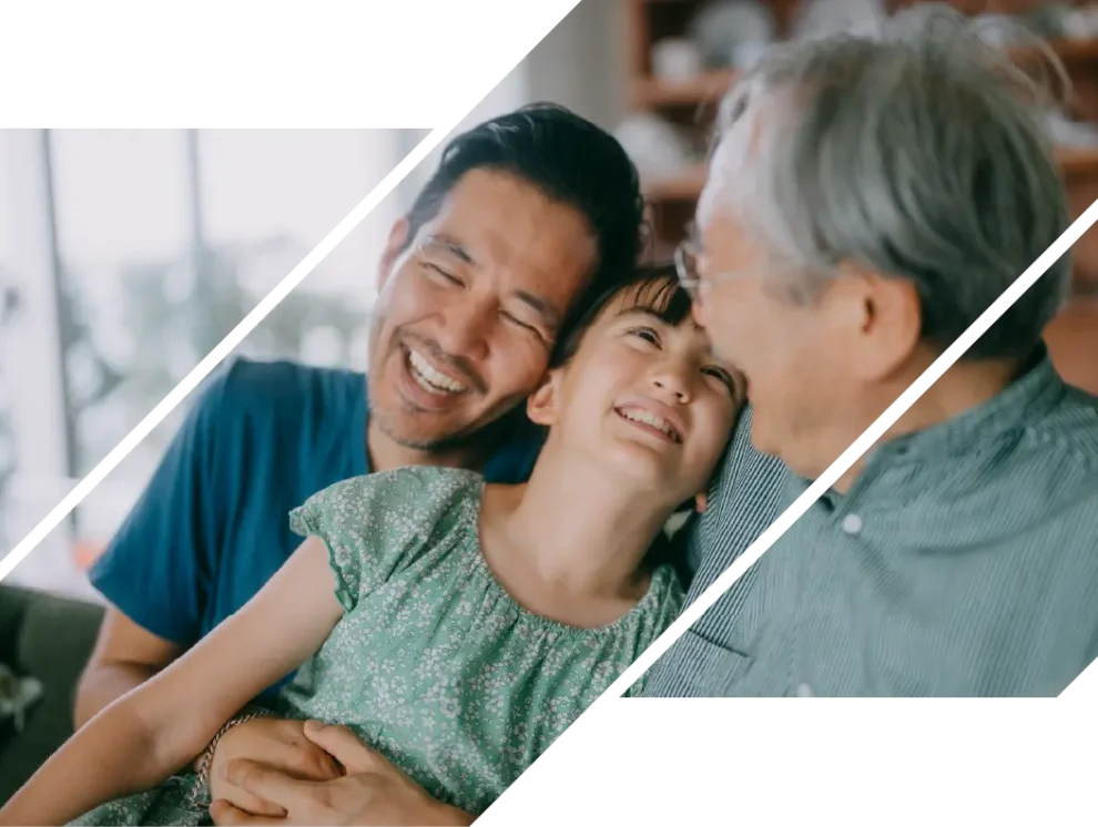 A man and girl laugh with an elderly man.