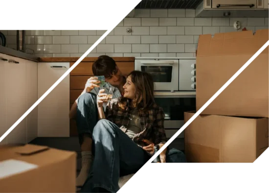 A man and woman sitting in a kitchen with moving boxes.