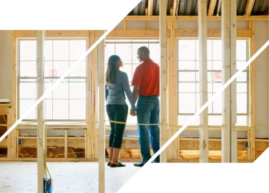 A couple stands in a house under construction and looks at each other.