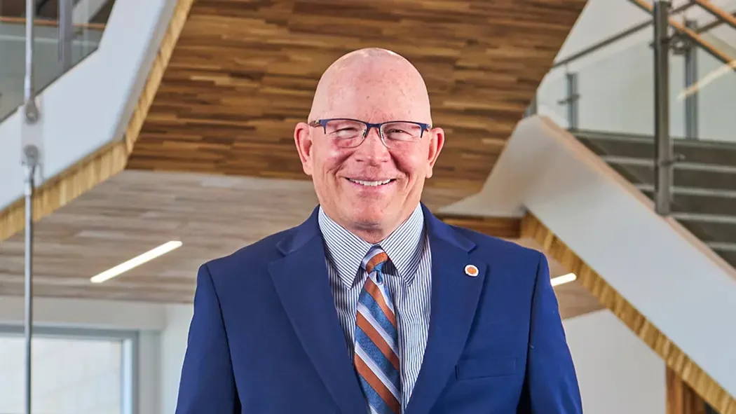 President and CEO of Idaho College of Osteopathic Medicine smiling.