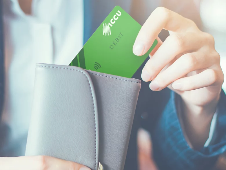 Women putting a debit card back in her wallet