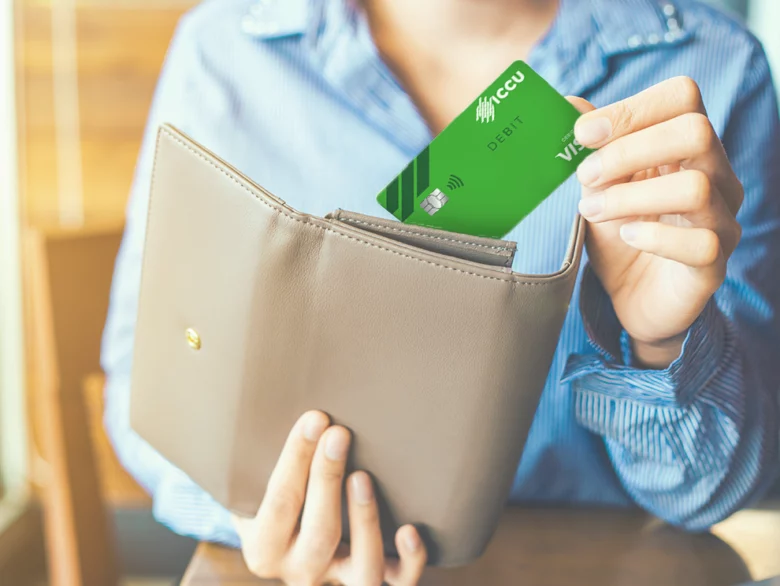 Person pulling Visa Debit card from wallet