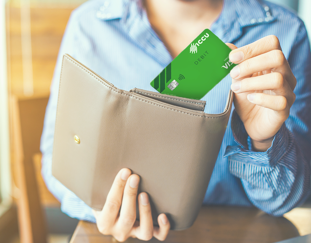 Person pulling Visa Debit card from wallet