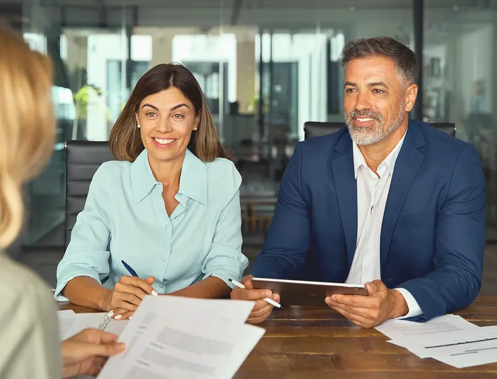 couple sitting down with financial advisor